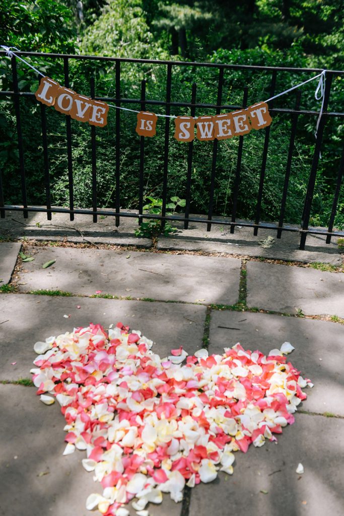 heart of rose petals in nyc with sign