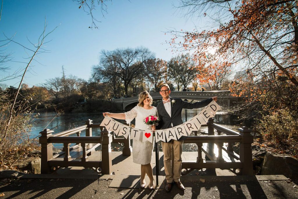 wedding signs just married at bow bridge