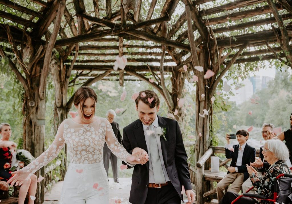 Just married couple gets petals thrown at them in Cop Cot Central Park Wedding