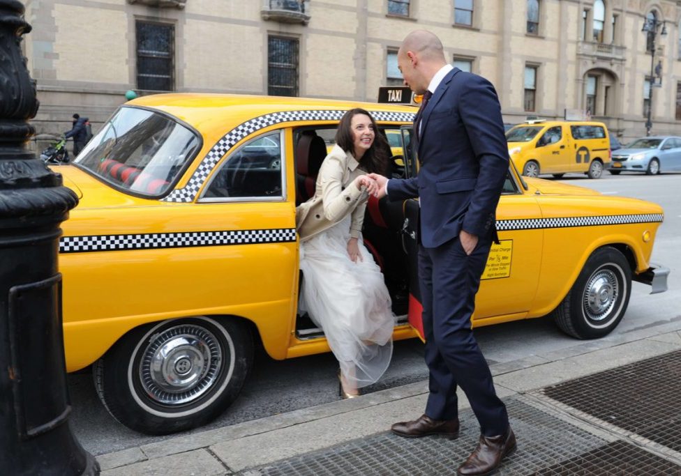 Bride getting off the vintage checkered cab, NYC wedding